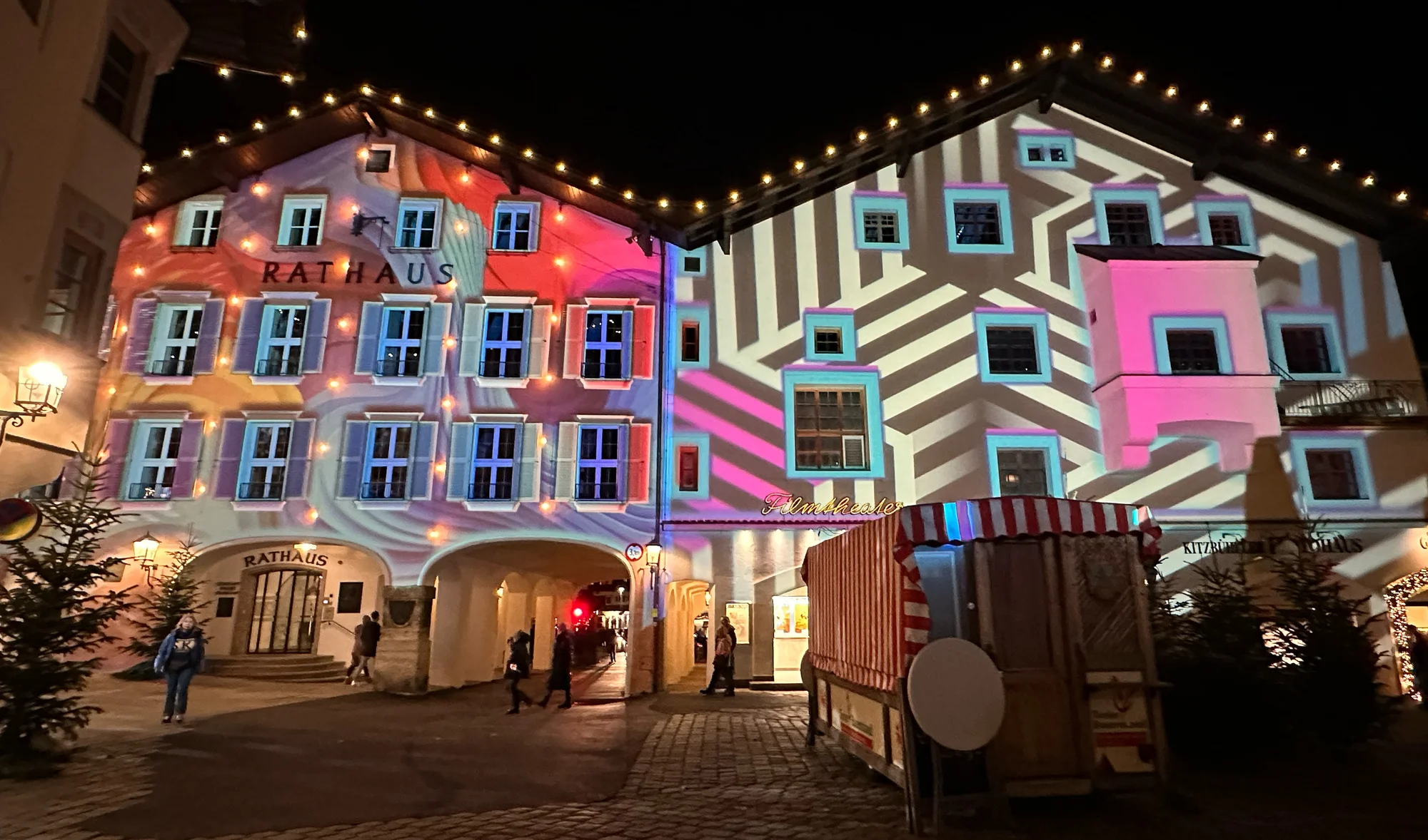 Geometric black and white patterns beside colourful facade projections