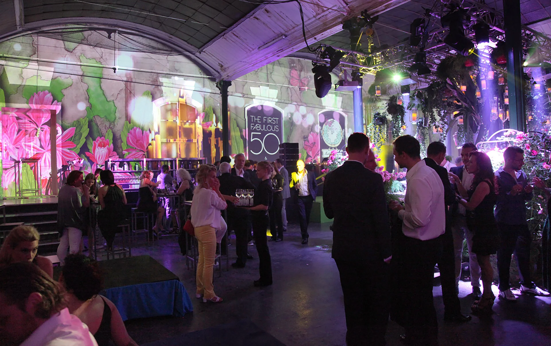 View through the event hall with pink and green spatial projections