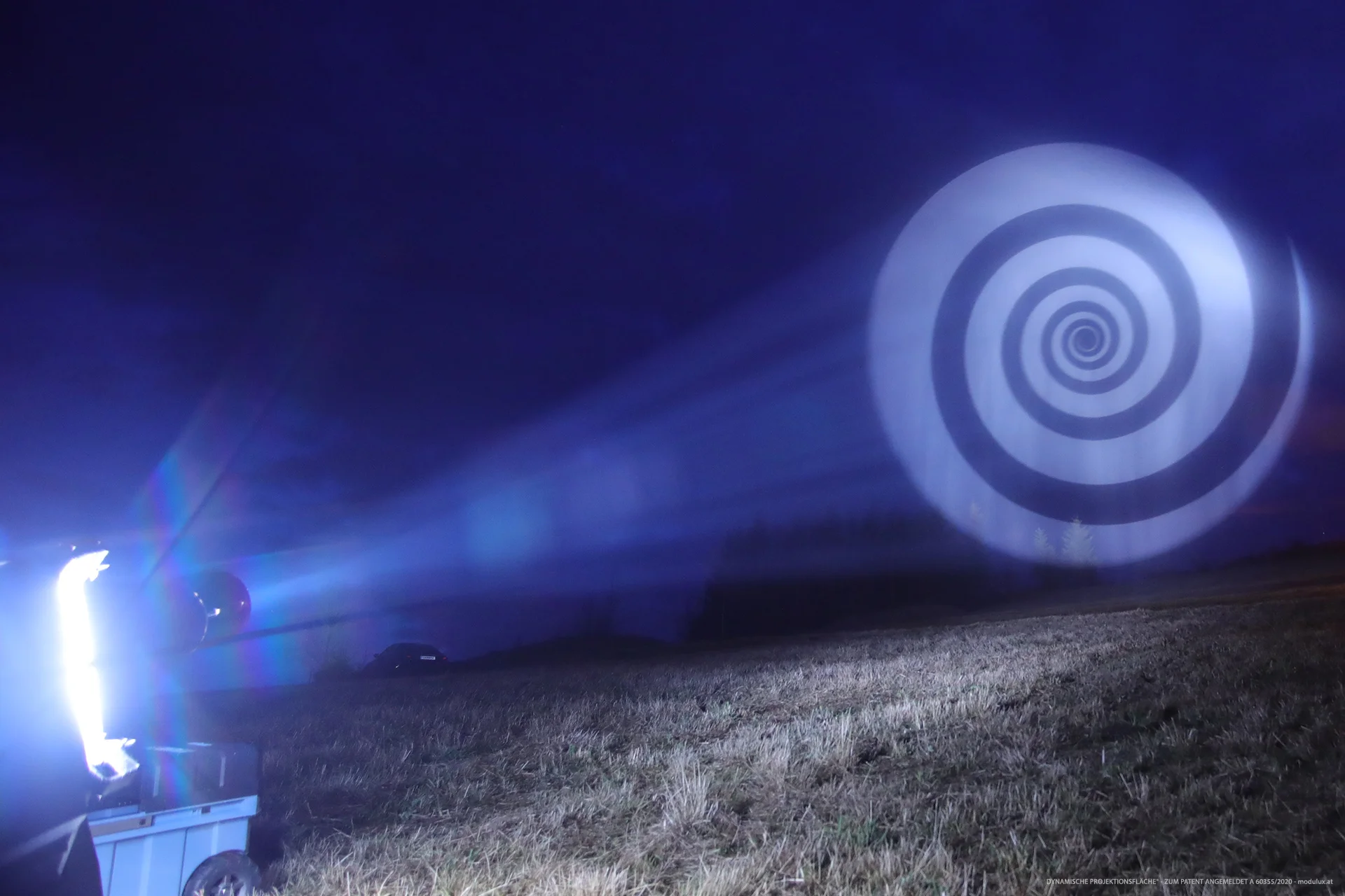 Spiral on water particles with a visible projection beam from the side