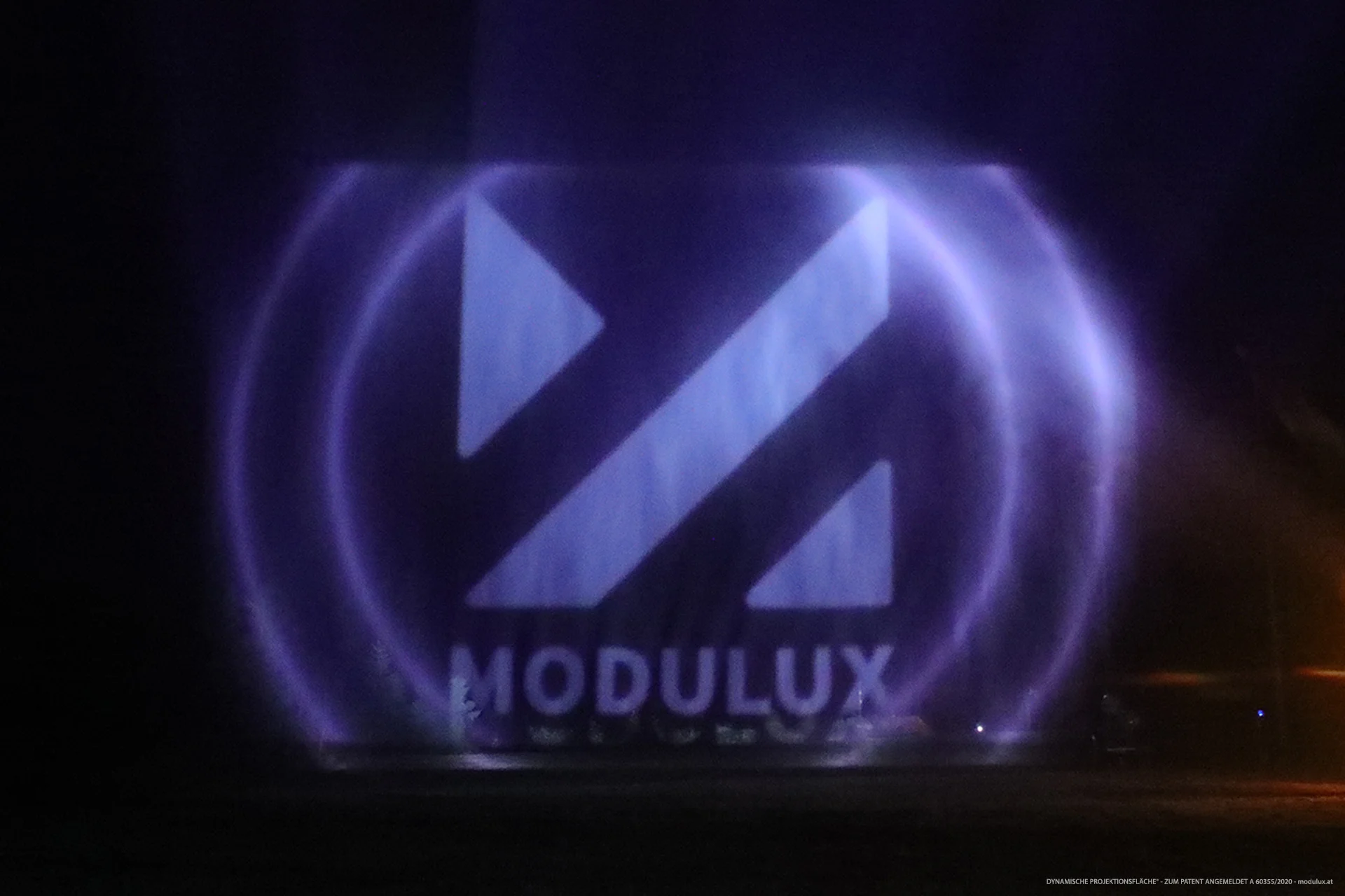 MODULUX lettering and geometric logo on violet-lit water particles
